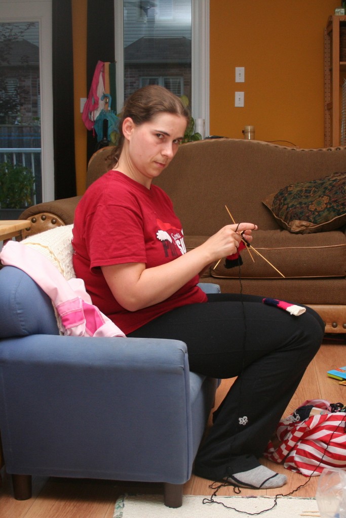 Mommy knitting on the teeny tiny couch.
