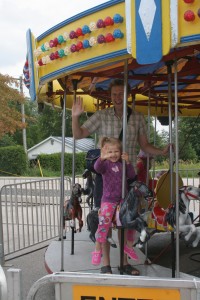 Steve and Lilly on the merry-go-round.